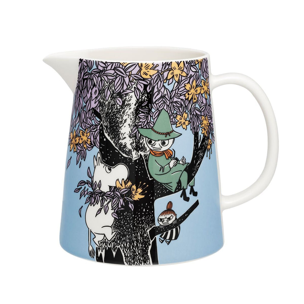 Pichet en porcelaine bleu à motif floral, avec anse et dessin d’arbre illustré